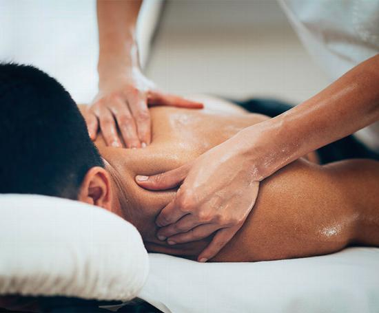 man getting sports massage while laying face down on table